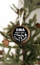 Load image into Gallery viewer, DNA Does Not Make a Family Love Does Christmas Ornament - Get 30% OFF + FREE Shipping When You Order 10 Or More.